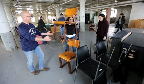 TREVOR HAGAN / WINNIPEG FREE PRESS Michel Aziza, Einat Keynan and Rachel Aziza, all from the Jewish community, along with several others, sorting donations for Yazidi refugees at a warehouse on Higgins Avenue, Sunday, February 28, 2016. for Carol Sanders story