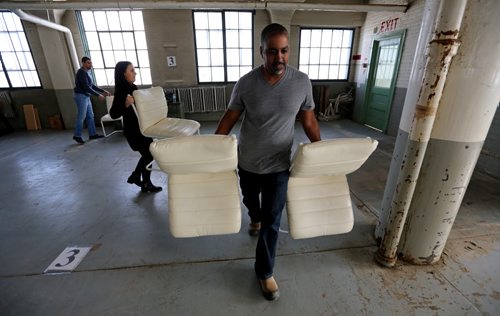 TREVOR HAGAN / WINNIPEG FREE PRESS  From left, Neni Mualem, Rachel Aziza and Itai Eliyahu, along with several others from the Jewish and from the Yazidi community, sorting donations for Yazidi refugees at a warehouse on Higgins Avenue, Sunday, February 28, 2016. for Carol Sanders story