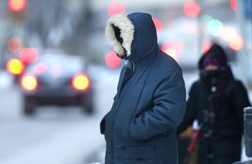 WAYNE GLOWACKI / WINNIPEG FREE PRESS Minimize any exposed skin out there Monday morning as the temperature dropped to -23C. Pedestrians brave the wind  crossing  Portage Ave. at Carlton Street. February 29 2016.