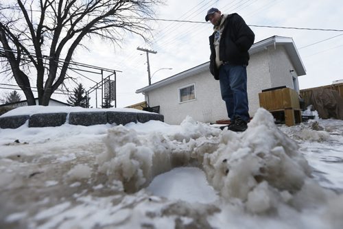 JOHN WOODS / WINNIPEG FREE PRESS David Gunson, scans the water damage on his St James property after a water main break Tuesday, March 1, 2016.