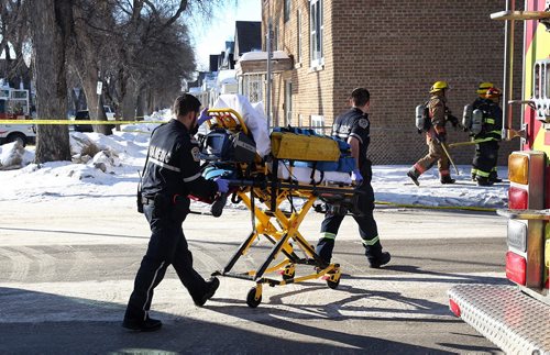 MIKE DEAL / WINNIPEG FREE PRESS Paramedics arrive at a fire at a house in the 500 block of Beverly Street at Sargent Avenue where two people were reported to have possible smoke inhalation. The fire damaged the house as well as destroyed the garage.   160302 March 02, 2016