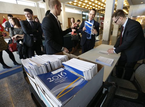 WAYNE GLOWACKI / WINNIPEG FREE PRESS  
   Reporters line up to receive their copy of the 2016 City of Winnipeg Preliminary Budget Wednesday as they head into a committee room at City Hall. Aldo Santin story March 2 2016