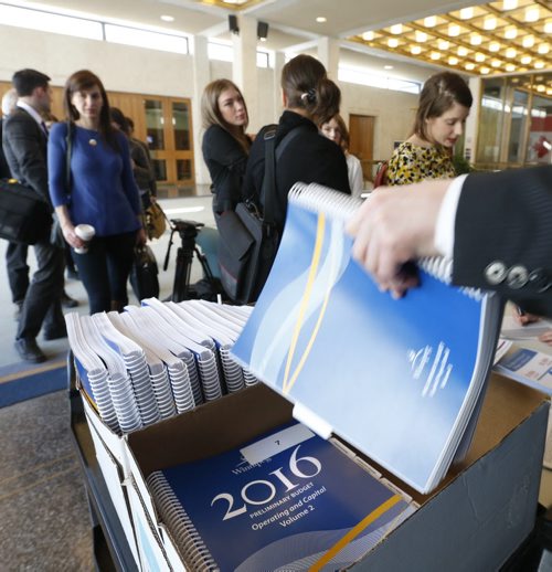 WAYNE GLOWACKI / WINNIPEG FREE PRESS 
    Reporters line up to receive their copy of the 2016 City of Winnipeg Preliminary Budget Wednesday as they head into a committee room at City Hall. Aldo Santin story  March 2 2016