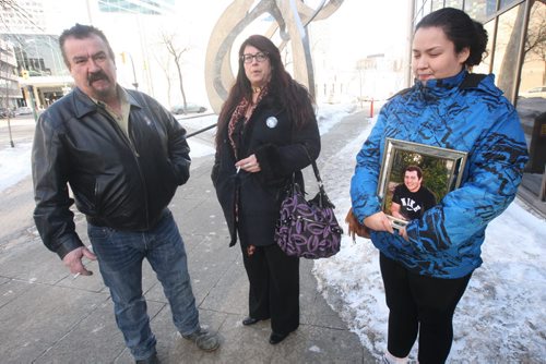 JOE BRYKSA / WINNIPEG FREE PRESS  Father  Daniel Joubert, mother Christine and sister Rejeanne  who holds photo of her deceased brother Robert Joubert outside Manitoba Law Courts where they were at the sentencing of Martin Jolicoeur who pleaded guilty to impaired driving that killed their son/brother Robert Joubert, 22 yrs, in a crash in June 2012 , March 02, 2016.(See Mike McIntyre story)