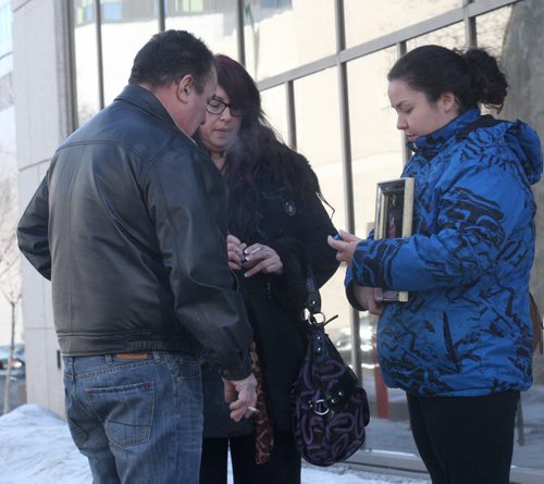 JOE BRYKSA / WINNIPEG FREE PRESS  Father  Daniel Joubert, mother Christine and sister Rejeanne  who holds photo of her deceased brother Robert Joubert outside Manitoba Law Courts where they were at the sentencing of Martin Jolicoeur who pleaded guilty to impaired driving that killed their son/brother Robert Joubert, 22 yrs, in a crash in June 2012 , March 02, 2016.(See Mike McIntyre story)