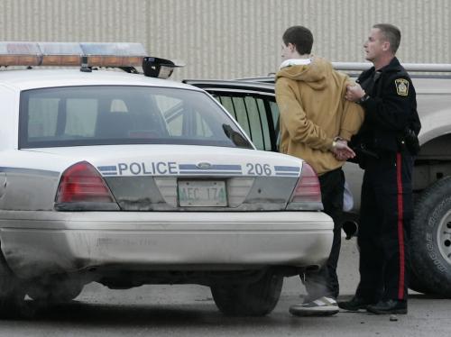 John Woods / Winnipeg Free Press / February 25, 2008 - 080225 - Officer takes a male into custody in the Canadian Tire parking lot. Police attend to a shooting at Polo Park Monday February 25, 2008.