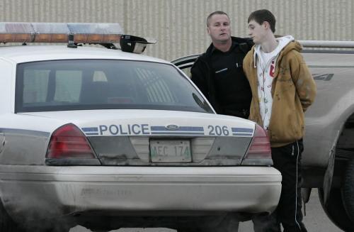 John Woods / Winnipeg Free Press / February 25, 2008 - 080225 - Officer takes a male into custody in the Canadian Tire parking lot.  Police attend to a shooting at Polo Park Monday February 25, 2008.