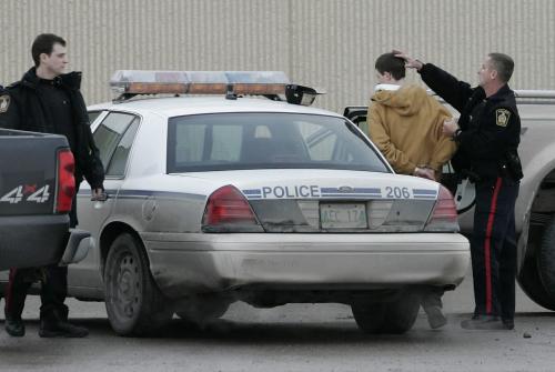 John Woods / Winnipeg Free Press / February 25, 2008 - 080225 - Officer takes a male into custody in the Canadian Tire parking lot. Police attend to a shooting at Polo Park Monday February 25, 2008.