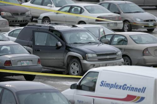 John Woods / Winnipeg Free Press / February 25, 2008 - 080225 - An SUV which may have been involved in a shooting incident at the Bay parking lot at Polo Park.  Police attend to a shooting at Polo Park Monday February 25, 2008.