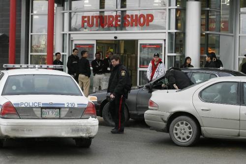 John Woods / Winnipeg Free Press / February 25, 2008 - 080225 - Officer investigate in the Future Shop  parking lot. May have taken someone into custody here.  Police attend to a shooting at Polo Park Monday February 25, 2008.