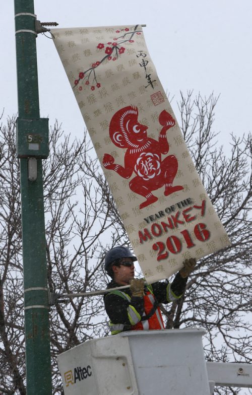 WAYNE GLOWACKI / WINNIPEG FREE PRESS  
   Dustin Kipling with Mytec Industries Ltd. installs the first 2016 Year of the Monkey Banner on King St. in Chinatown Friday morning.  This banner replaces the 2015 Year of the Sheep banner. The Winnipeg Chinese Cultural and Community Centre along with the Downtown Winnipeg BIZ has been displaying banners since 1991 as a way to celebrate the downtown culture. see release March 4 2016