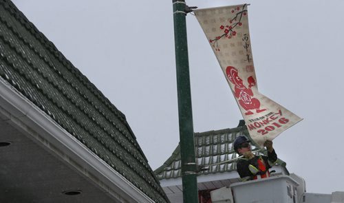 WAYNE GLOWACKI / WINNIPEG FREE PRESS   
   Dustin Kipling with Mytec Industries Ltd. installs a new 2016 Year of the Monkey Banner on King St. in Chinatown Friday morning.  This banner replaces the 2015 Year of the Sheep banner. The Winnipeg Chinese Cultural and Community Centre along with the Downtown Winnipeg BIZ have been displaying banners since 1991 as a way to celebrate the  downtown culture. see release March 4 2016