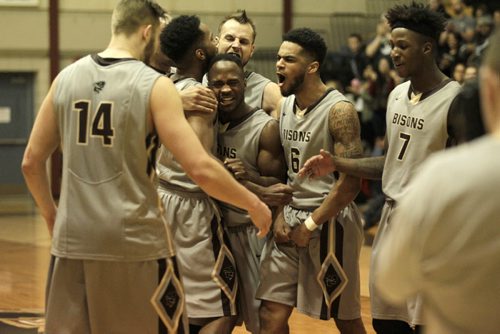 RUTH BONNEVILLE / WINNIPEG FREE PRESS Manitoba Bisons Basketball players celebrate their win in overtime against the Fraser Valley Cascades during the Canada West quarter-final series at the Investors Group Athletic Centre Friday evening.    March 3rd, 2016