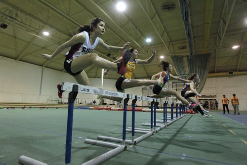 RUTH BONNEVILLE / WINNIPEG FREE PRESS Cassidy Schindel of Sisler High School (on end) competes with eight other young women in the Youth, 60 meter hurdles event at the 2016 Boeing Indoor Classic at James Daly Fieldhouse Friday evening.   March 4th, 2016