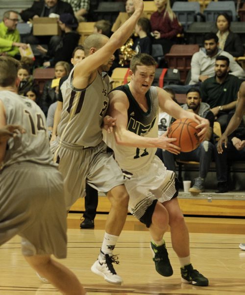 RUTH BONNEVILLE / WINNIPEG FREE PRESS Fraser Valley Cascades Basketbal player #12 Matt Cooley tries to past  Manitoba Bisons player #2 Keith Omoerah during the first half of the game in the Canada West quarter-final  series at the Investors Group Athletic Centre Friday evening.    March 3rd, 2016