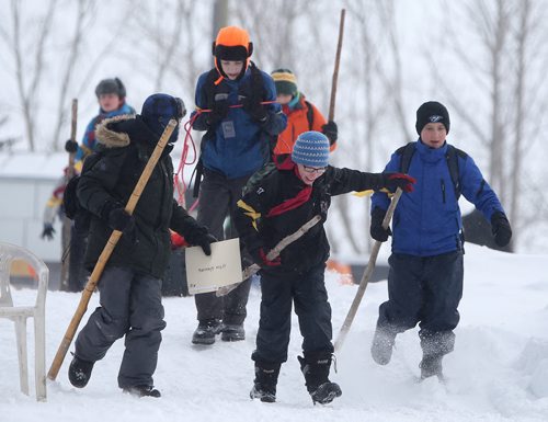 JASON HALSTEAD / WINNIPEG FREE PRESS  Members of the 49th Winnipeg Scout troop get started as more than 300 Scouts tested their survival skills in Scouts Canadas annual Klondike Derby on March 5, 2016, at Camp Amisk south of Winnipeg. Teams of six to eight Cub Scouts, Scouts, Girl Guides and Pathfinders pulled a Klondike-style sleigh over a 2.5-kilometre course through the woods, competing at tasks including fire lighting, a flood disaster scenario and a simulated ice rescue.