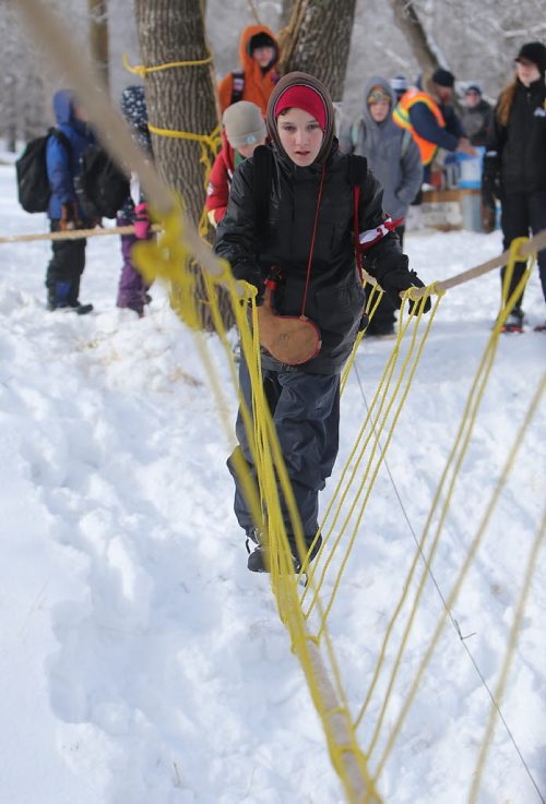 JASON HALSTEAD / WINNIPEG FREE PRESS  Ian Argue, 12, of the 60th Winnipeg Scout troop tries to cross a rope bridge as more than 300 Scouts tested their survival skills in Scouts Canadas annual Klondike Derby on March 5, 2016, at Camp Amisk south of Winnipeg. Teams of six to eight Cub Scouts, Scouts, Girl Guides and Pathfinders pulled a Klondike-style sleigh over a 2.5-kilometre course through the woods, competing at tasks including fire lighting, a flood disaster scenario and a simulated ice rescue.