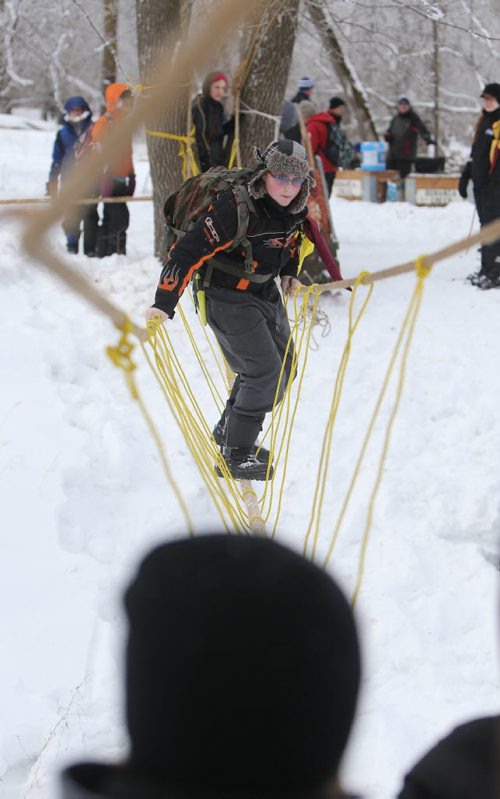 JASON HALSTEAD / WINNIPEG FREE PRESS  Jacob Jeswiet, 11, of the 16th Winnipeg Scout troop tries to cross a rope bridge as more than 300 Scouts tested their survival skills in Scouts Canadas annual Klondike Derby on March 5, 2016, at Camp Amisk south of Winnipeg. Teams of six to eight Cub Scouts, Scouts, Girl Guides and Pathfinders pulled a Klondike-style sleigh over a 2.5-kilometre course through the woods, competing at tasks including fire lighting, a flood disaster scenario and a simulated ice rescue.