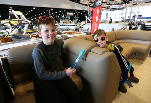 JASON HALSTEAD / WINNIPEG FREE PRESS  Brothers Ethan Atkins, 8, and Jake, 6, check out a Bennington pontoon boat at the West Hawk Marine diplay at the Mid-Canada Boat Show at the RBC Convention Centre Winnipeg on March 5, 2016. (See Rollason story)