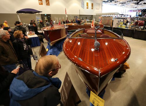 JASON HALSTEAD / WINNIPEG FREE PRESS  Visitors check out vintage restored boats at the Peterson Boat Works display at the Mid-Canada Boat Show at the RBC Convention Centre Winnipeg on March 5, 2016. (See Rollason story)