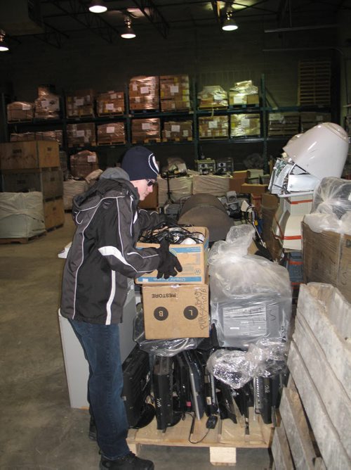 Canstar Community News March 3, 2016 - Jarett King delivers a box of household electronics to Computers for Schools at 75 Terracon Place in the Terracon Industrial Park. One of several approved drop-off locations in innipeg, it is open between 8:30 and 4:30 weekdays.