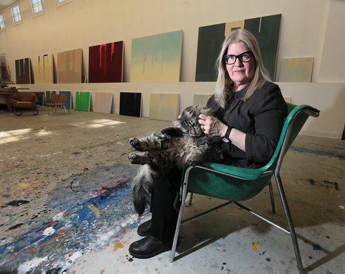 PHIL HOSSACK / WINNIPEG FREE PRESS Flanked by some of her large canvasses, Winnipeg artist Wanda Koop nuzzles her cat George. re: Gov. General's Award. See story. March 7, 2016