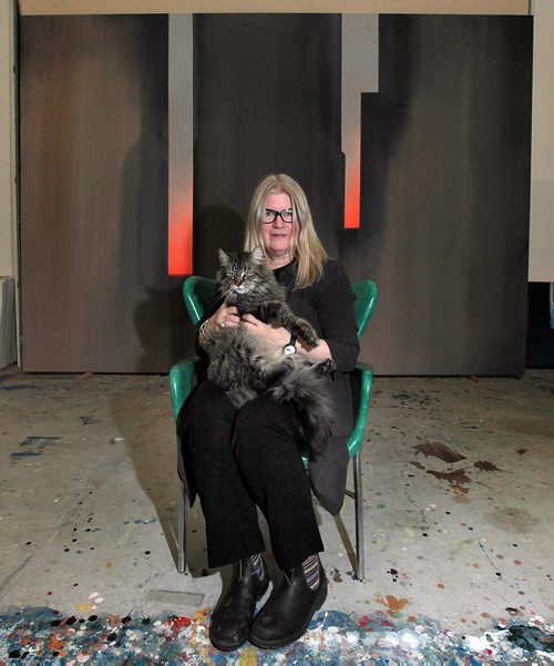 PHIL HOSSACK / WINNIPEG FREE PRESS Framed in one of her large canvasses, Winnipeg artist Wanda Koop poses with her cat George in her studio Monday. re: Gov. General's Award. See story. March 7, 2016
