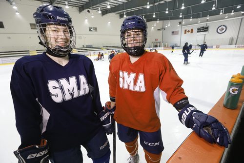 JOHN WOODS / WINNIPEG FREE PRESS St Mary's Academy Flames' Kyra (K.K.) Thiessen (L) and captain Kayla Friesen are photographed at practice Monday, March 7, 2016. Thiessen has committed to play NCAA Division I at Mercyhurst, and Friesen, who has played on Team Canada U18, has committed to play at St. Cloud University.