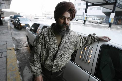 John Woods / Winnipeg Free Press / February 27, 2008 - 080227 - Gurmit Singh Brar, standing beside his limo at the airport, speaks about the call for more cabs in Winnipeg by Gail Asper and the Winnipeg Taxi Board Wednesday February 27, 2008.  When we left Brar he had been waiting for a fare for 1 hour 45 minutes.