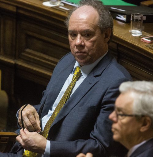 MIKE DEAL / WINNIPEG FREE PRESS Finance Minister Greg Dewar waits while the opposition attempts to keep him from presenting the Fiscal Outlook at the Manitoba Legislature Tuesday afternoon. 160308 - Tuesday, March 08, 2016