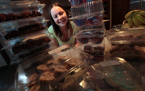 PHIL HOSSACK / WINNIPEG FREE PRESS Reese Precourt (15) poses in her family kitchen with a portion of the baking she's prepped for this Saturday's Bake Sale in support of Lighthouse Mission. See Ashley Prest story.  March 8, 2016