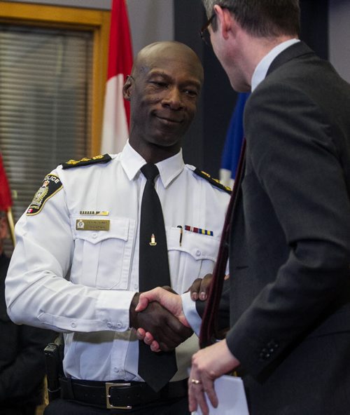 MIKE DEAL / WINNIPEG FREE PRESS Winnipeg Police Chief, Devon Clunis shakes Mayor Brian Bowman's hand after announcing his retirement at the Public Safety Building Thursday, March 10, 2016. 160310 - Thursday, March 10, 2016