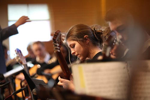 RUTH BONNEVILLE / WINNIPEG FREE PRESS Kelsey Wiebe plays the guitar with 64 other members of J H Bruns  guitar orchestra for the Wpg Music Festival at Westwood United Church Thursday afternoon.   March 10, 2016