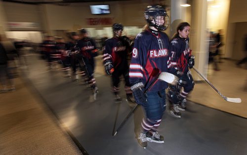 PHIL HOSSACK / WINNIPEG FREE PRESS St Mary's Academy Flames stride through the spedtator consession area after their first period against the Notre Dame Hounds Thursday evening at the Ice Plex during World Sport School Challenge. See Tim Campbell story.  March 10, 2016
