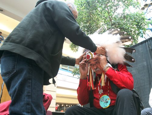 JOE BRYKSA / WINNIPEG FREE PRESS  Veteran - Elder Joseph Meconse was kicked out of Portage Place in Feb of this year, today there was a gathering in the mall to honour the elder- Here he gets his War bonnet placed on his head at beginning of ceremony-  March 11, 2016.(See Jen Zoratti story)