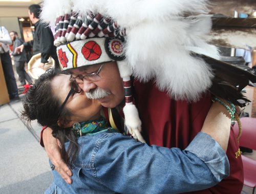 JOE BRYKSA / WINNIPEG FREE PRESS  Veteran - Elder Joseph Meconse was kicked out of Portage Place in Feb of this year, today there was a gathering in the mall to honour the elder-  Friend Marilyn Harris kisses  Elder Joseph Meconse after formal apology-  March 11, 2016.(See Jen Zoratti story)