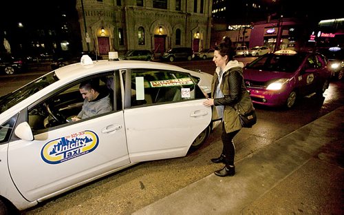 PHIL HOSSACK / WINNIPEG FREE PRESS Jenn Zoratti climbs into the back of a Unicity Cab downtown THursday evening. See her story.   March 10, 2016