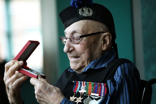 RUTH BONNEVILLE / WINNIPEG FREE PRESS  HONOURING A HERO -- 2nd World War Veteran, Mr. John Johnson, holds the Legion of Honour Medal at Deer Lodge Hospital where he was presented with the medal at formal ceremony Saturday.   See Kevin Rollason's story.  March 12, 2016