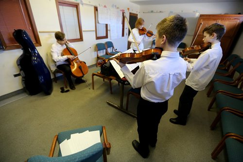 TREVOR HAGAN / WINNIPEG FREE PRESS From left, Nicholas Harder, 14, Fiona Young, 14, River Sawchyn, 13, and William Harder, 12, the Wolseley Quartet preparing for their performance at Young United Church during the Winnipeg Music Festival, Friday, March 11, 2016.