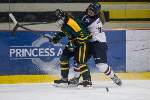 MIKE DEAL / WINNIPEG FREE PRESS St. Mary's Academy Flames' Kayla Friesen (18) is checked off the puck by Balmoral Hall Blazers' Taylor Tom (5) in the bronze medal game of the 2016 Female World Sport School Challenge at the MTS IcePlex on Sunday. 160313 - Sunday, March 13, 2016