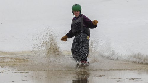 MIKE DEAL / WINNIPEG FREE PRESS Martin Porter, 10, plows across a pool of water at the bottom of a hill at the Stony Mountain Ski  Area during the annual Stony Slush Cup event. 160313 - Sunday, March 13, 2016