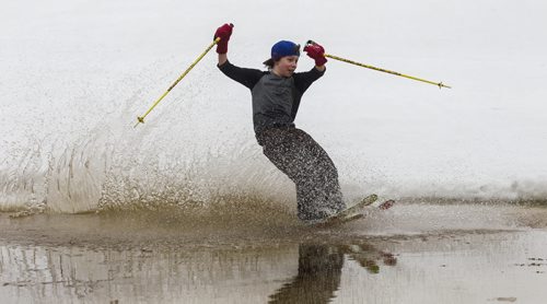 MIKE DEAL / WINNIPEG FREE PRESS Rowan Parnell, 11, flies across a pool of water at the bottom of a hill at the Stony Mountain Ski  Area during the annual Stony Slush Cup event. 160313 - Sunday, March 13, 2016