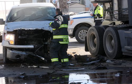 ¬JOE BRYKSA / WINNIPEG FREE PRESS  A semi trailer attempting to do a u turn at Spruce St and Portage ave has collided with a pickup truck- The large truck is blocking all of  westbound Portage Ave- The truck is also blocking two lanes East bound on Portage Ave  Injuries appear to be minor-  March 14, 2016.(Breaking News)