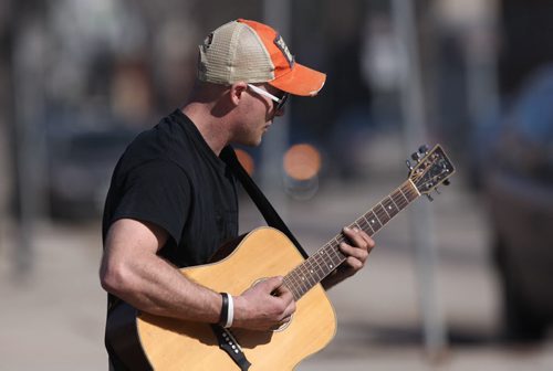 JOE BRYKSA / WINNIPEG FREE PRESS  Luke Drewitt plays his guitar while busking Monday afternoon on Corydon Ave enjoying 10 C weather -  March 14, 2016.(Standup Photo )