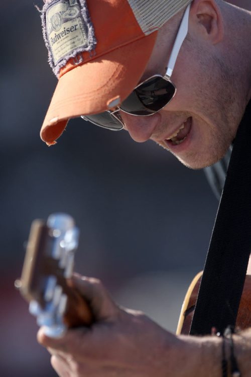 JOE BRYKSA / WINNIPEG FREE PRESS  Luke Drewitt plays his guitar while busking Monday afternoon on Corydon Ave enjoying 10 C weather -  March 14, 2016.(Standup Photo )