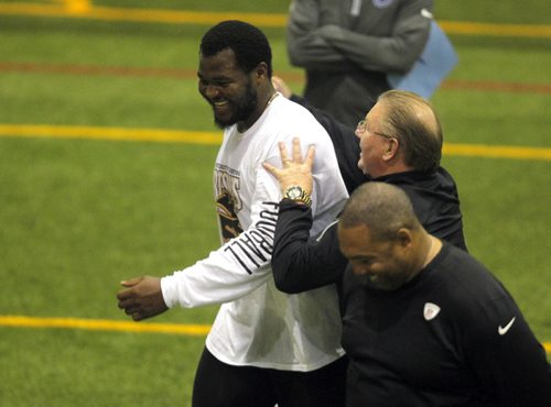 BORIS MINKEVICH / WINNIPEG FREE PRESS Bison David Onyemata pro day football workout at the University of Manitoba. Onyemata is the first Manitoba Bisons to hold a pro day football workout.  At least 12-16 NFL scouts and coaches were there. In this photo New Orleans Saints defensive line coach Bill Johnson, back right, give David a pat on the back while Philadelphia Eagles defensive line coach Chris Wilson, bottom right, watches. Photo taken March 14, 2016