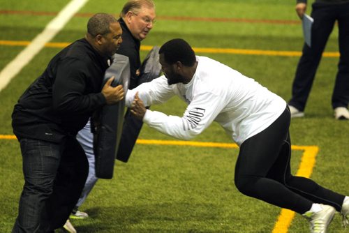 BORIS MINKEVICH / WINNIPEG FREE PRESS Bison David Onyemata pro day football workout at the University of Manitoba. Onyemata is the first Manitoba Bisons to hold a pro day football workout.  At least 12-16 NFL scouts and coaches were there.In this photo New Orleans Saints defensive line coach Bill Johnson, top left,  and Philadelphia Eagles defensive line coach Chris Wilson, bottom left,  work with David, right. Photo taken March 14, 2016
