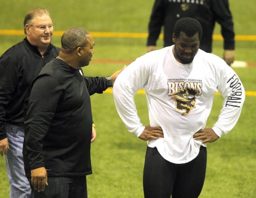 BORIS MINKEVICH / WINNIPEG FREE PRESS Bison David Onyemata pro day football workout at the University of Manitoba. Onyemata is the first Manitoba Bisons to hold a pro day football workout.  At least 12-16 NFL scouts and coaches were there.(left to right) In this photo New Orleans Saints defensive line coach Bill Johnson and Philadelphia Eagles defensive line coach Chris Wilson work with David. Photo taken March 14, 2016