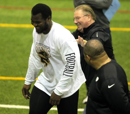 BORIS MINKEVICH / WINNIPEG FREE PRESS Bison David Onyemata pro day football workout at the University of Manitoba. Onyemata is the first Manitoba Bisons to hold a pro day football workout.  At least 12-16 NFL scouts and coaches were there. In this photo New Orleans Saints defensive line coach Bill Johnson, back right, give David a pat on the back while Philadelphia Eagles defensive line coach Chris Wilson, bottom right, watches. Photo taken March 14, 2016
