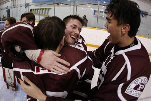 JOHN WOODS / WINNIPEG FREE PRESS St Paul's Crusaders' Nick Johnson (18), goaltender C.J. Harrison (1) and Kyle Morton (17) celebrate defeating Vincent Massey Trojans at the Provincial High School AAAA final Monday, March 13, 2016 at St James Civic Centre.
